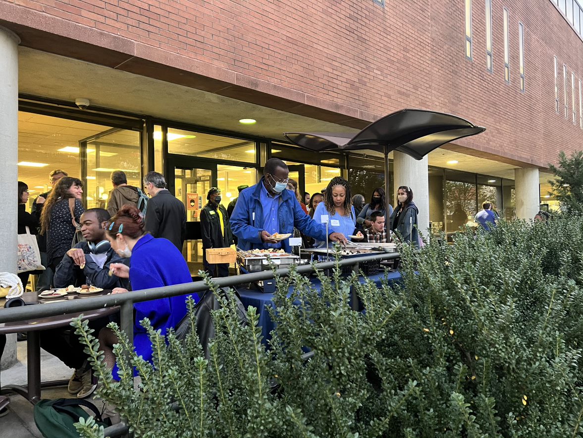 People standing together on the patio outside the W. W. Hagerty Library with catering